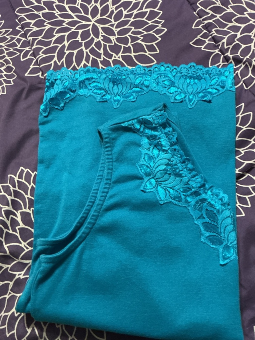 aqua blue Serengeti tank top has delicate lace trim along the v-neckline , hem